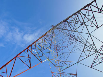 Low angle view of high voltage tower in blue sky screen