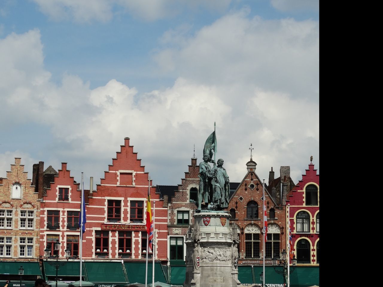 STATUE IN CITY AGAINST SKY