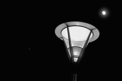 Low angle view of lamp lit up at night