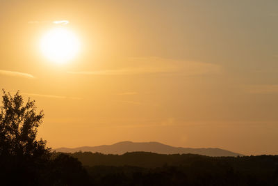 Scenic view of silhouette mountains against sky during sunset
