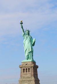 Low angle view of statue of liberty against sky