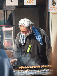 Midsection of man preparing food