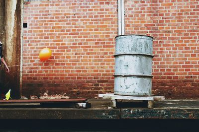 View of bell on brick wall against building