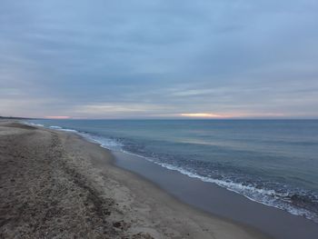 Scenic view of beach against sky during sunset