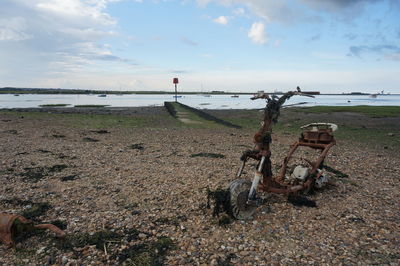 A rusted bike abandoned on a beach in kent uk.