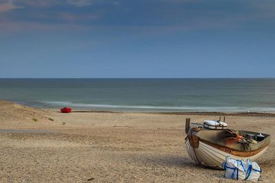 Scenic view of beach against clear sky