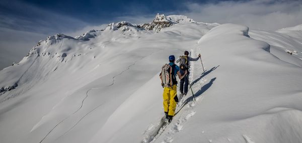 People skiing on snowcapped mountain