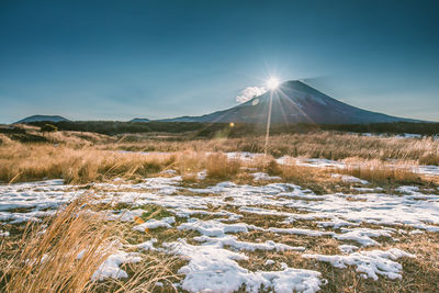 Scenic view of snowcapped mountains against sky during winter