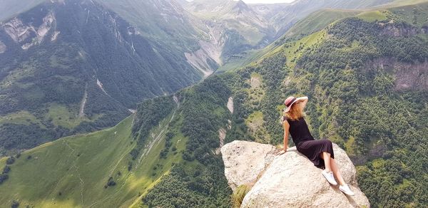 Man standing on rocks against mountains