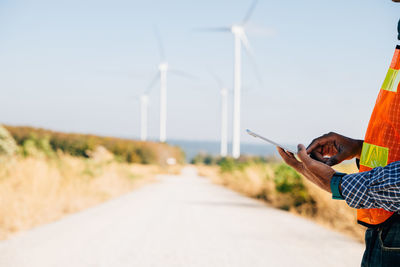 Rear view of man holding umbrella