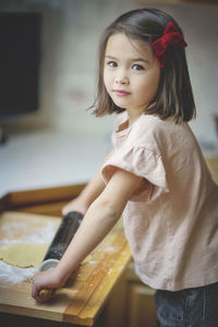 Portrait of cute girl standing at home