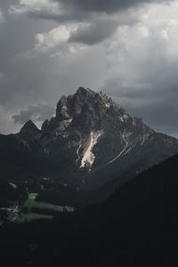 Scenic view of mountains against cloudy sky