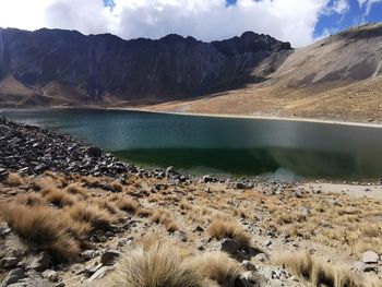 Scenic view of lake and mountains against sky