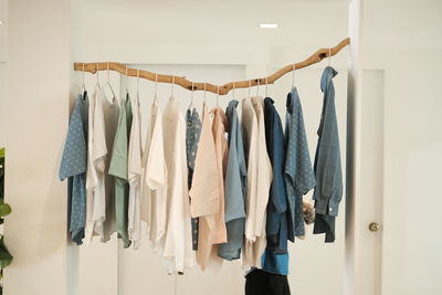 Row of clothes hanging on wall at home
