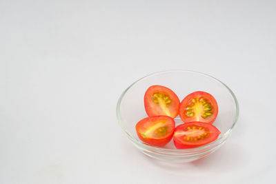 High angle view of fruits in glass over white background