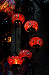 Low angle view of illuminated lanterns hanging at night