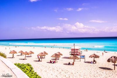 Scenic view of beach against blue sky