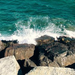 Waves breaking on rocks at shore