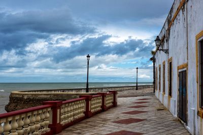 Street by sea against sky