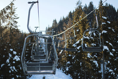 Close-up of ski lift against sky