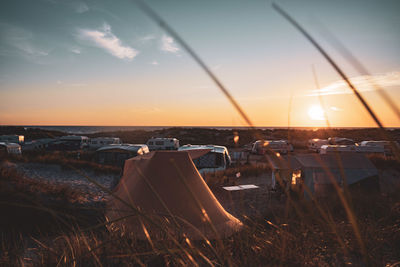 Scenic view of sea against sky during sunset with tent