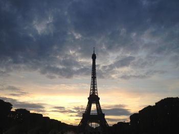 Low angle view of tower against cloudy sky