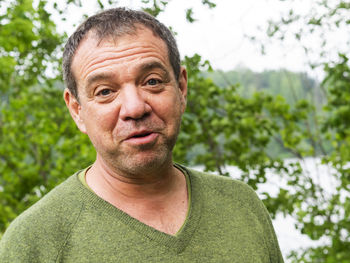 Portrait of mid adult man against plants