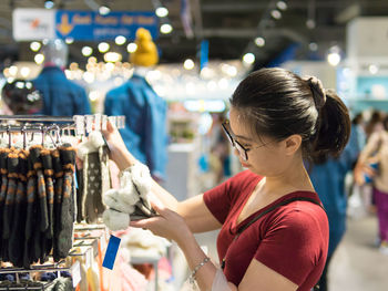 Woman buying socks in supermarket