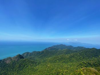 Scenic view of mountains against blue sky