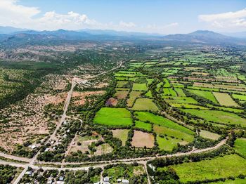 Aerial view of agricultural field against sky