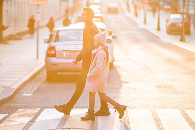 Woman with umbrella on street in city