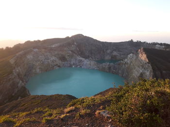 Scenic view of lake and mountains against sky