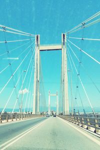 Low angle view of suspension bridge against sky