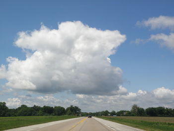 Empty road against cloudy sky