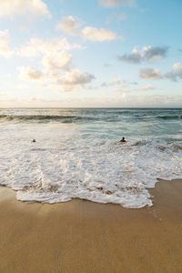 Scenic view of sea against cloudy sky