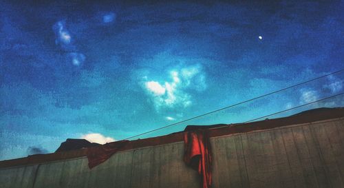 Low angle view of house against cloudy sky