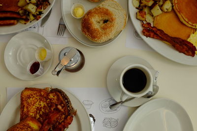 Directly above shot of food and black coffee on table