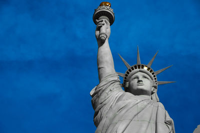 Low angle view of statue against blue sky