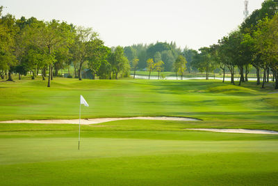 Scenic view of golf course against sky