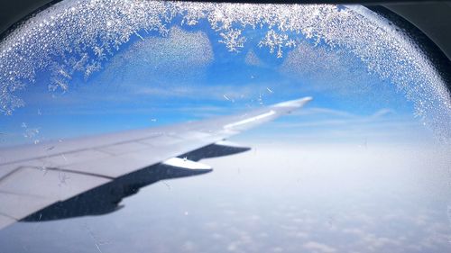 Aerial view of clouds seen through airplane window