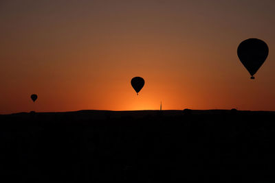 Silhouette of hot air balloon against sky during sunset