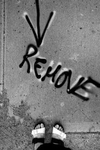 Low section of man standing on text