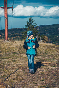 Full length of boy standing on field