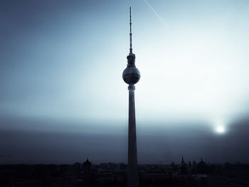 Communications tower in city at night