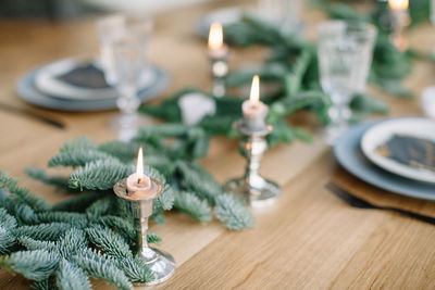 Close-up of burning candles during christmas on table at home