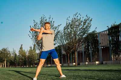 Full length of young man exercising at park