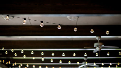 Retro light bulbs hanging in department store, with decorate interior luxury
