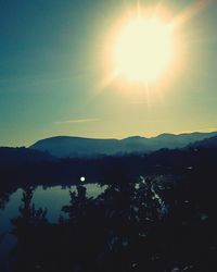 Scenic view of silhouette mountains against sky during sunset