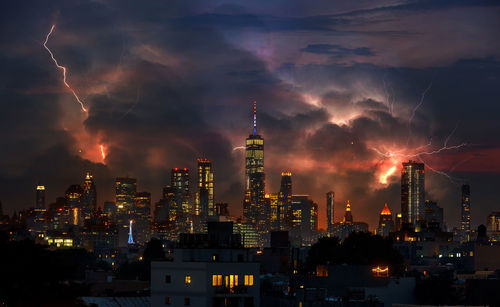 Panoramic view of illuminated buildings against sky at night