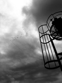 Low angle view of silhouette birds flying against sky